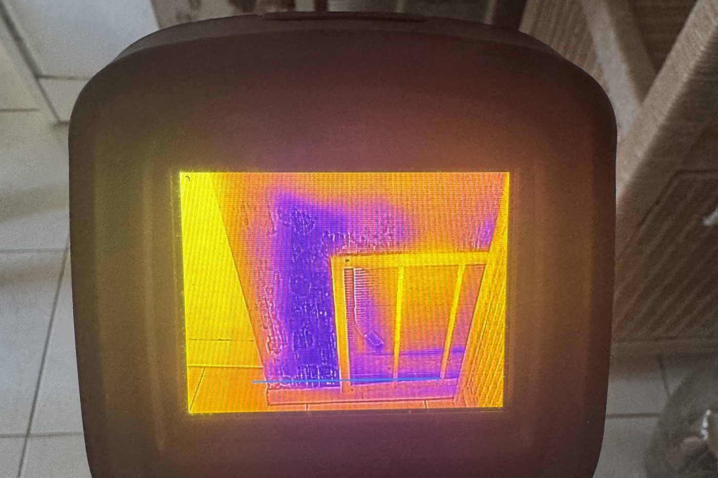 Thermal imaging camera showing hidden moisture inside a wall during a RapidDry inspection